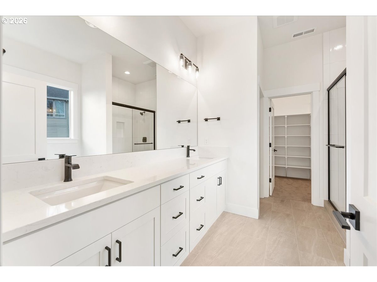 737 Southeast Forest Glen Road Estacada, OR 97023 - Photo 20 of 47 a bathroom with a double vanity sink double mirror and a bathtub