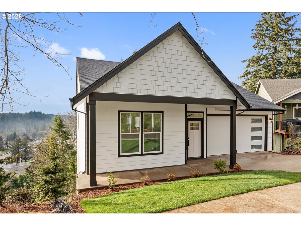 737 Southeast Forest Glen Road Estacada, OR 97023 - Photo 2 of 47 a front view of a house with a yard and garage