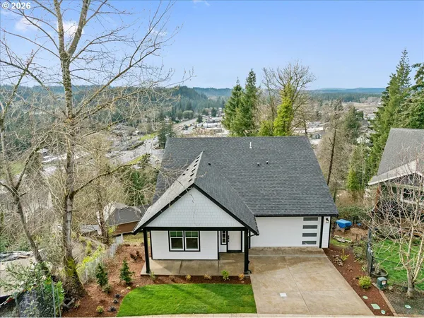 a aerial view of a house next to a yard