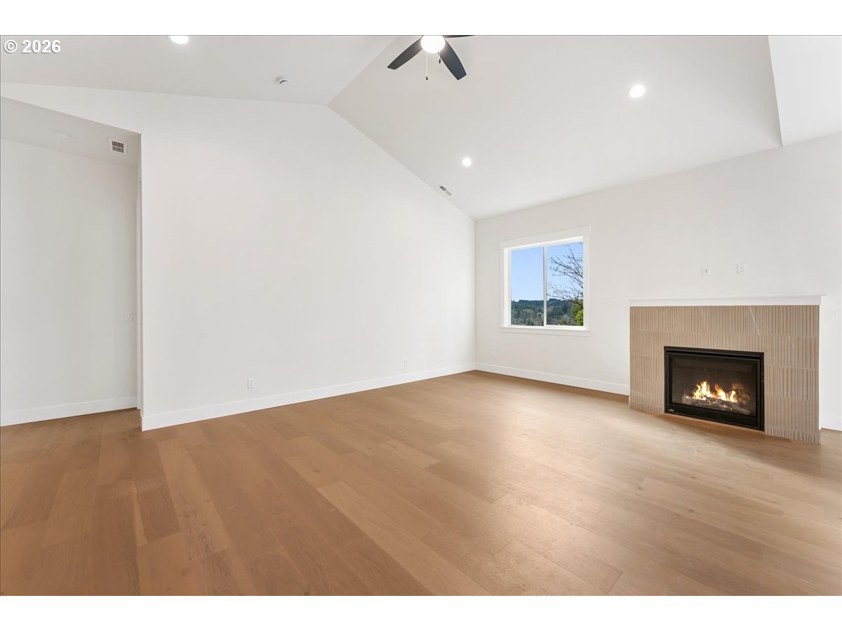 737 Southeast Forest Glen Road Estacada, OR 97023 - Photo 6 of 47 a view of an empty room with a fireplace and a window
