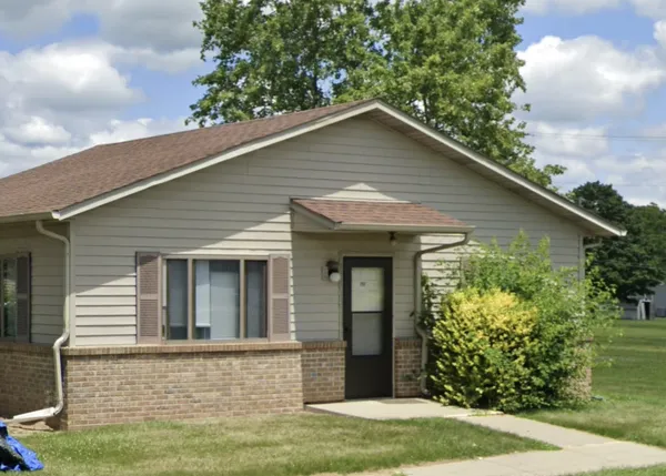 a house that has a tree in front of it