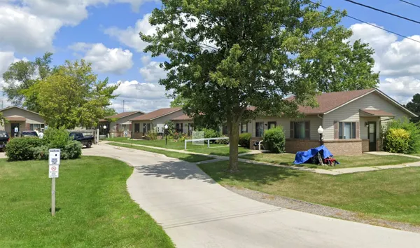a garden with trees in front of it