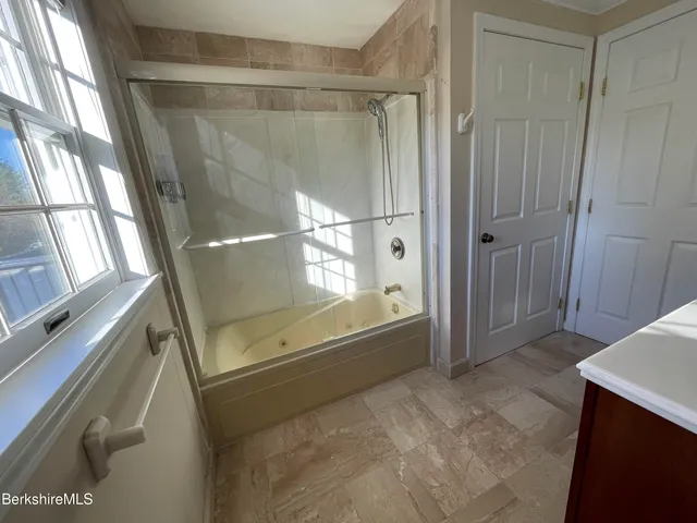 a bathroom with a tub and a shower