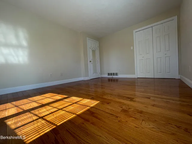 a view of a room with wooden floor