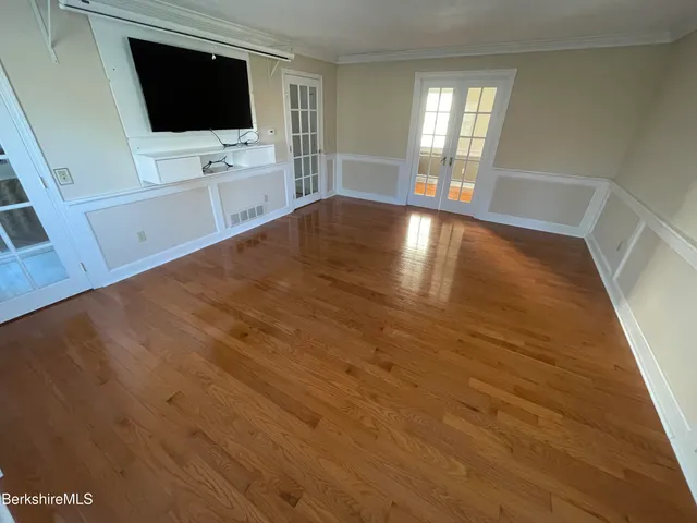 a view of wooden floor and windows in a room