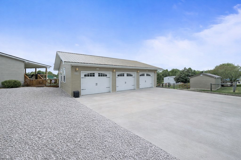 103 Molten Lane Hilham, TN 38568 - Photo 2 of 39 a view of garage with a small yard