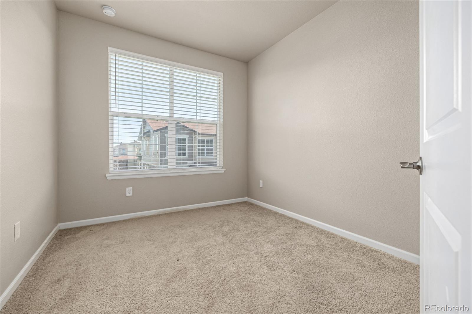 8417 Rizza Street, Unit A Littleton, CO 80129 - Photo 12 of 25 an empty room with windows