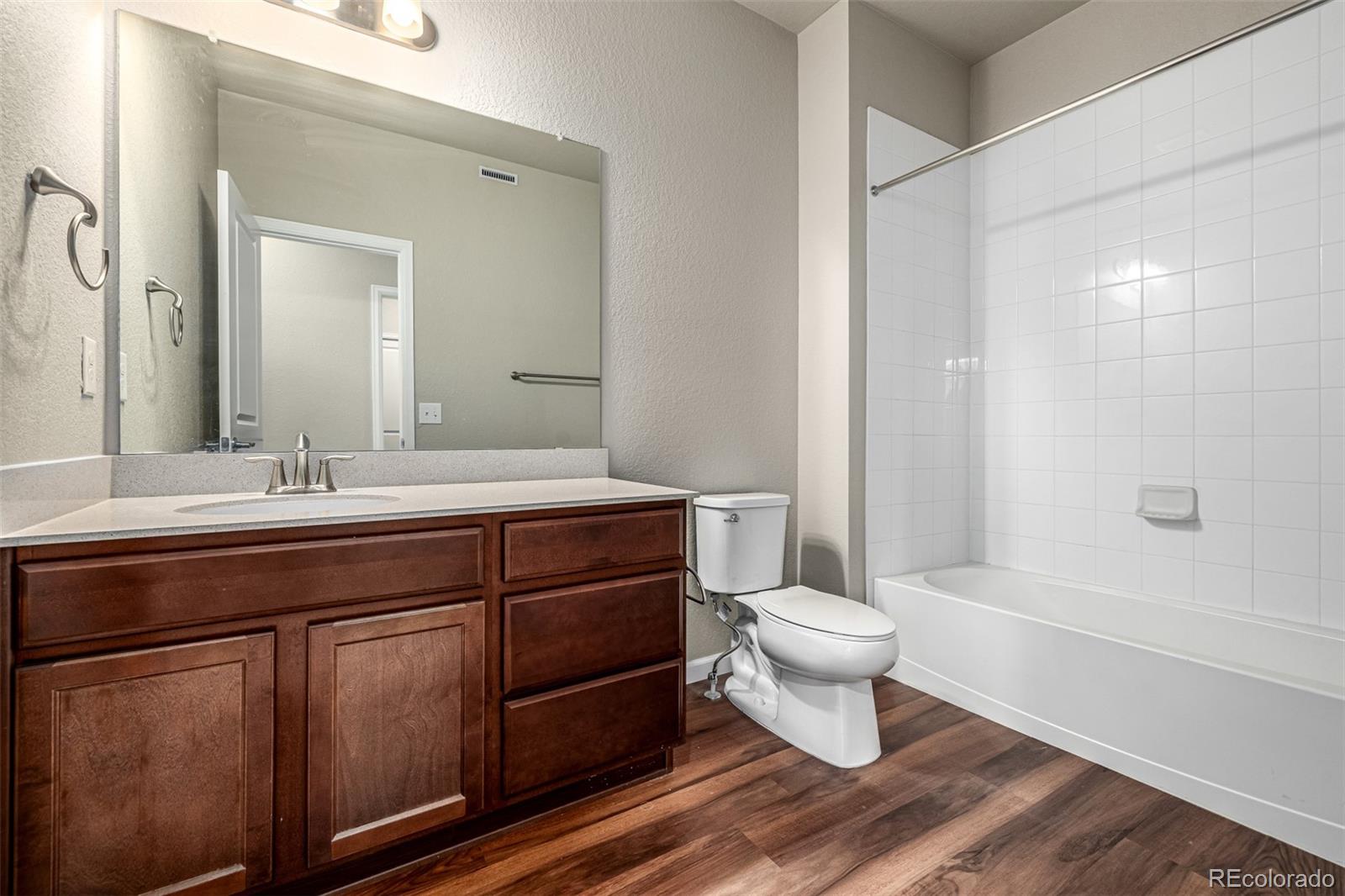 8417 Rizza Street, Unit A Littleton, CO 80129 - Photo 13 of 25 a bathroom with a sink toilet and a mirror