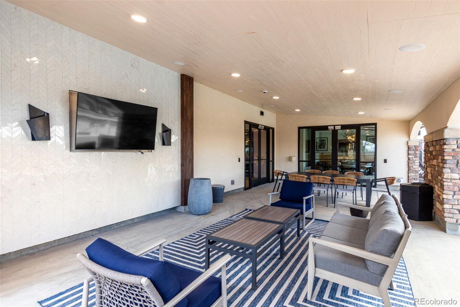 8417 Rizza Street, Unit A Littleton, CO 80129 - Photo 16 of 25 a living room with furniture and a flat screen tv