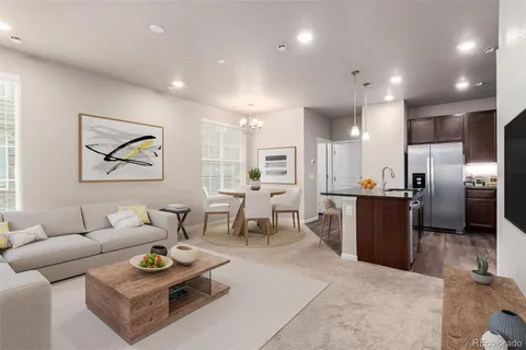 a living room with furniture kitchen view and a refrigerator