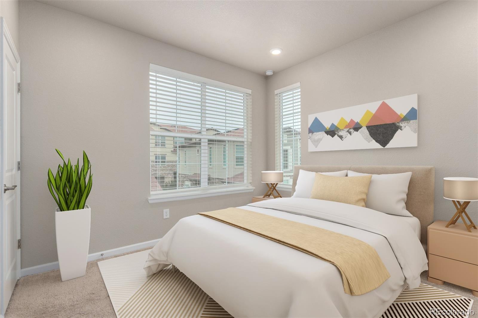 8417 Rizza Street, Unit A Littleton, CO 80129 - Photo 8 of 25 a bedroom with a bed and a couch