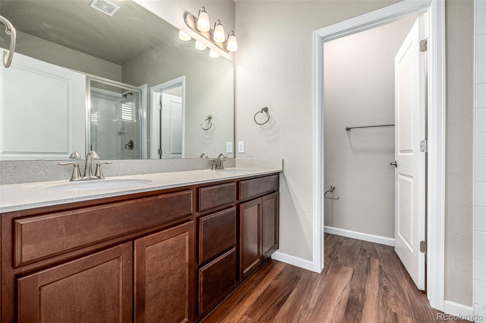 8417 Rizza Street, Unit A Littleton, CO 80129 - Photo 9 of 25 a spacious bathroom with a double vanity sink and a mirror