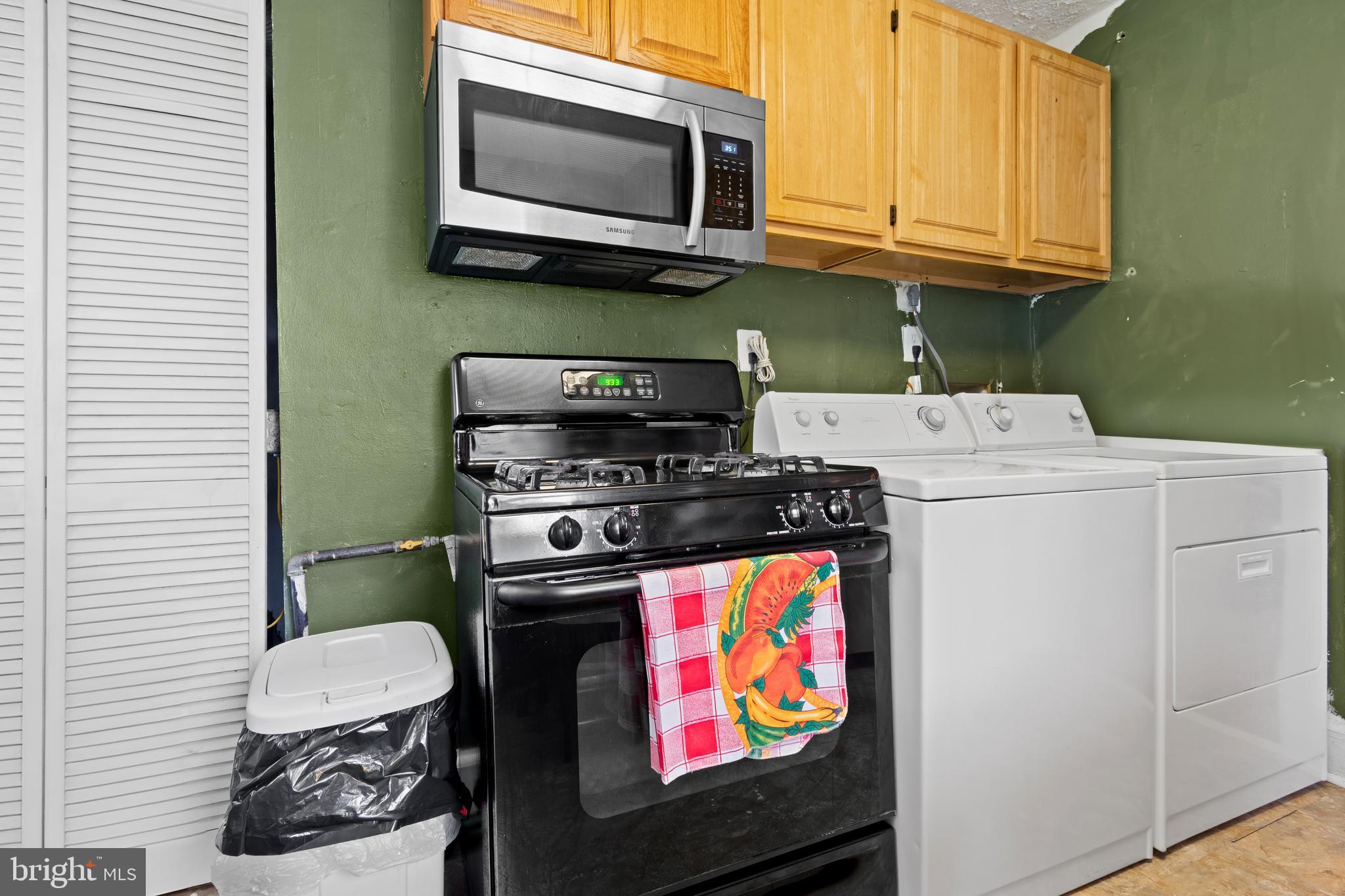 4410 Allies Road Suitland, MD 20746 - Photo 10 of 30 a kitchen with stainless steel appliances a stove a microwave and sink