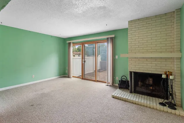 a room with window and a fireplace