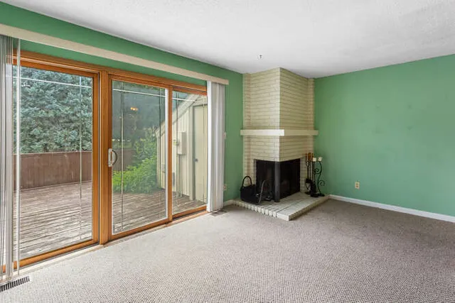 a view of a room with a fireplace and a window