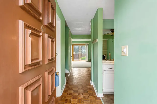 a view of a brick house with a door and windows