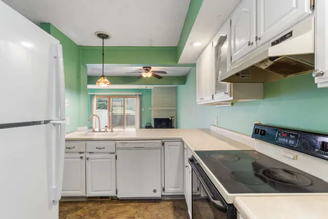 a kitchen with a sink and a stove top oven