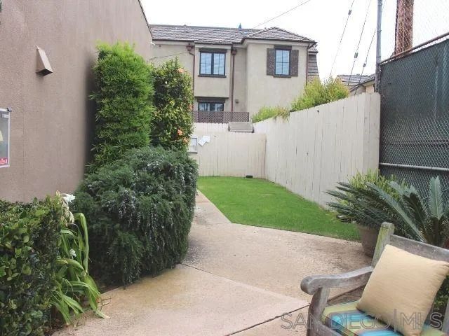 aerial view of a house with a yard and potted plants