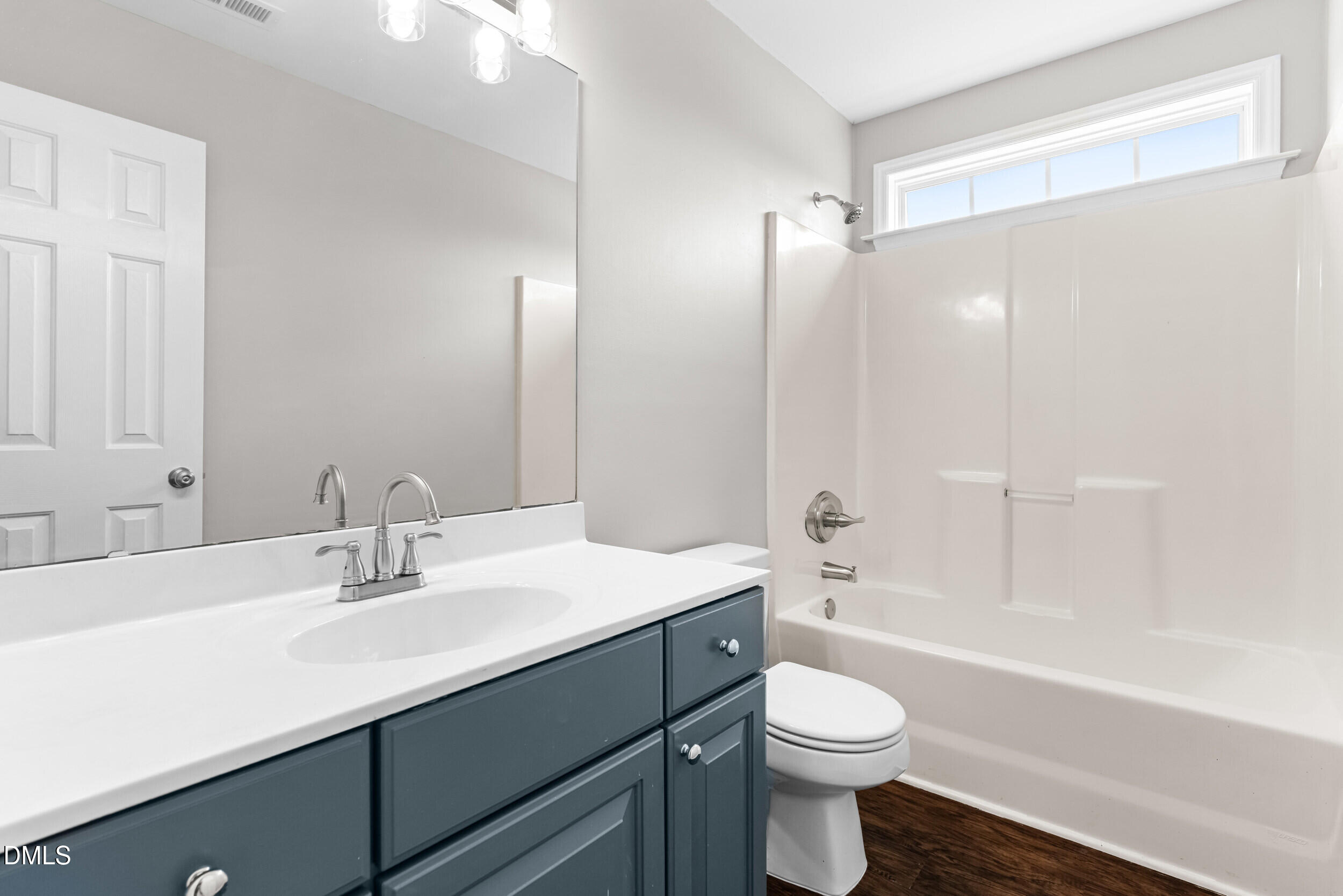 744 Seastone Street Raleigh, NC 27603 - Photo 39 of 53 a bathroom with a sink a toilet a mirror and shower