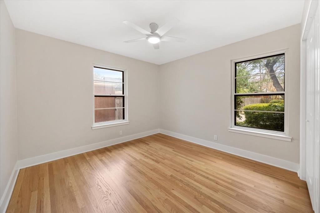 10524 Coleridge Street Dallas, TX 75218 - Photo 18 of 35 a view of an empty room with wooden floor and a window
