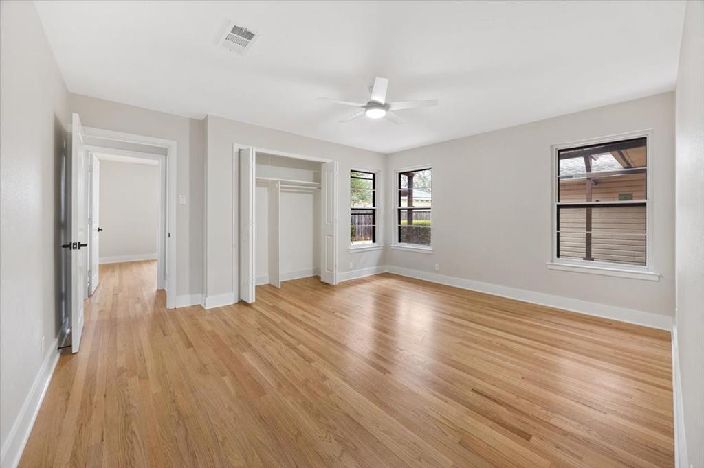 10524 Coleridge Street Dallas, TX 75218 - Photo 19 of 35 a view of an empty room with wooden floor and a window