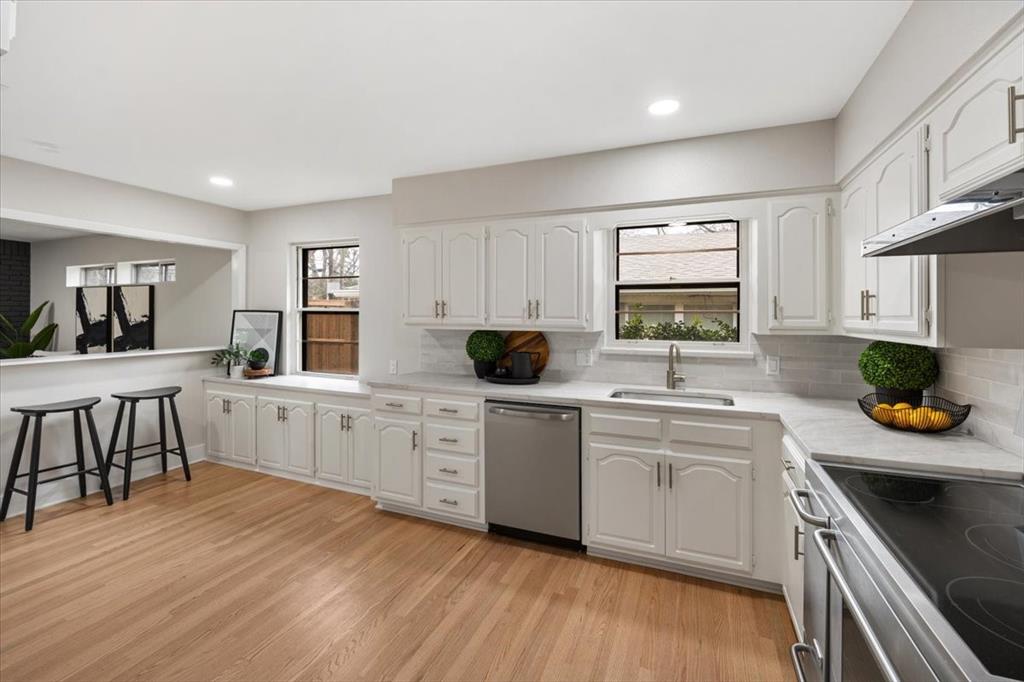 10524 Coleridge Street Dallas, TX 75218 - Photo 21 of 35 a kitchen with white cabinets and appliances