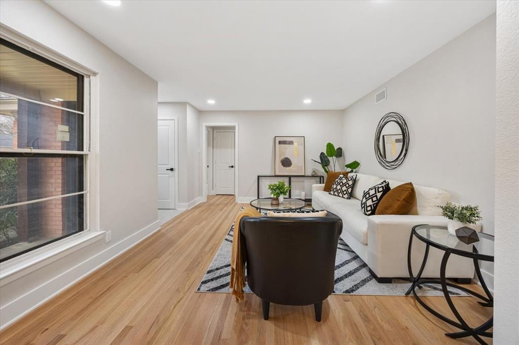 10524 Coleridge Street Dallas, TX 75218 - Photo 5 of 35 a living room with furniture a table and wooden floor