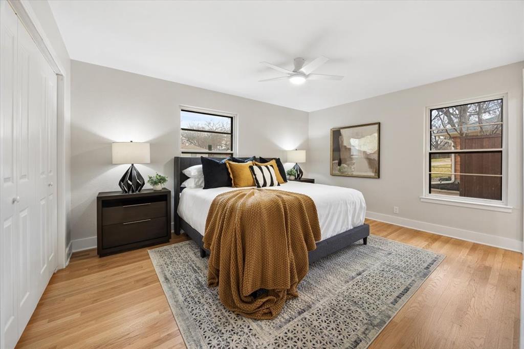 10524 Coleridge Street Dallas, TX 75218 - Photo 7 of 35 a bedroom with a bed and wooden floor
