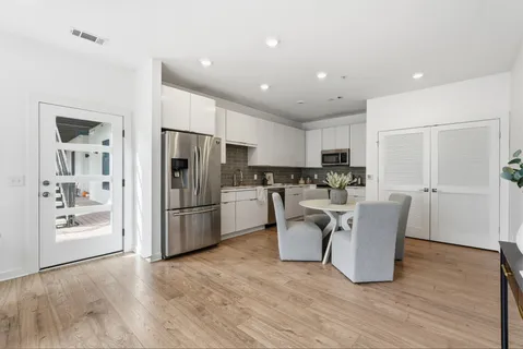 a kitchen with stainless steel appliances a refrigerator and a stove top oven