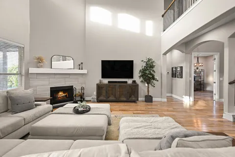 a living room with furniture a flat screen tv and a fireplace