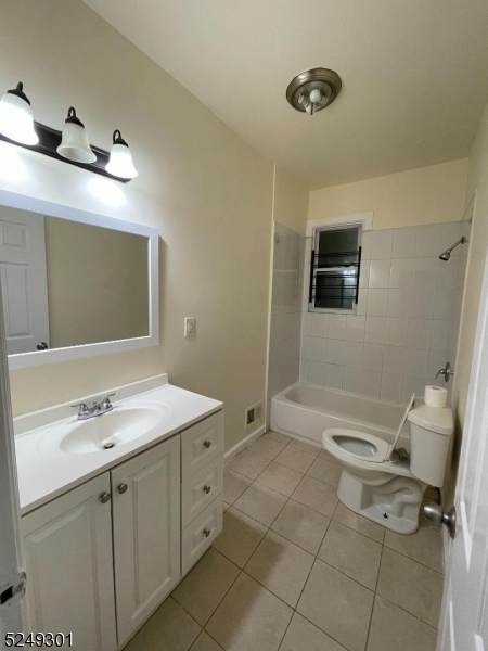 89 Cutler Street, Unit 1 Newark, NJ 07104 - Photo 2 of 7 a bathroom with a sink a toilet and mirror