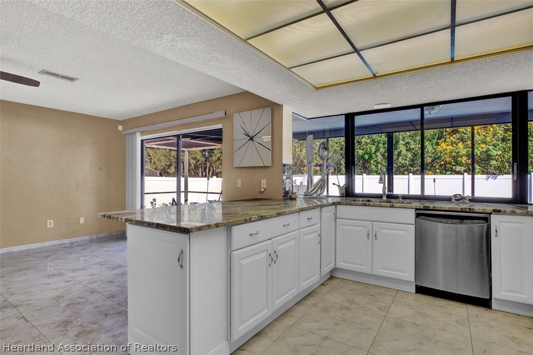 4204 Medina Way Sebring, FL 33875 - Photo 11 of 25 a kitchen with granite countertop a stove sink and microwave