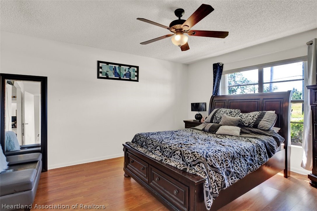 4204 Medina Way Sebring, FL 33875 - Photo 13 of 25 a bedroom with a large bed and a large window