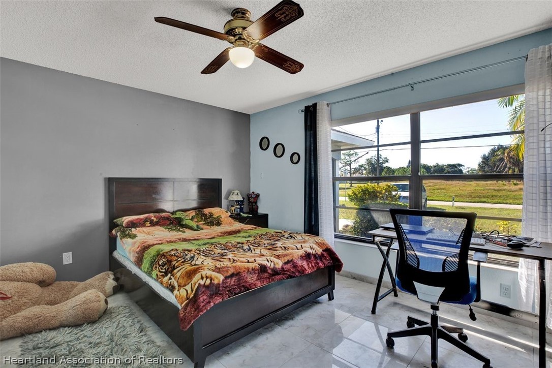 4204 Medina Way Sebring, FL 33875 - Photo 14 of 25 a bedroom with a bed and a large window