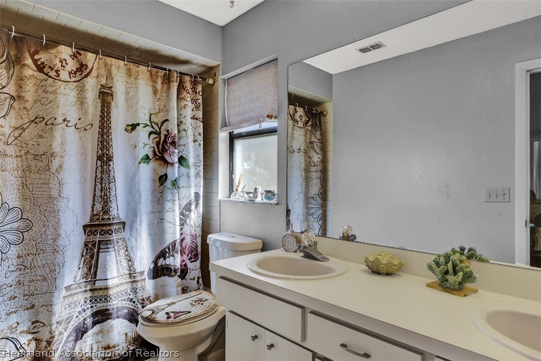 4204 Medina Way Sebring, FL 33875 - Photo 16 of 25 a bathroom with a sink toilet and shower