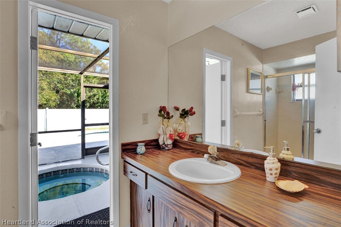 4204 Medina Way Sebring, FL 33875 - Photo 18 of 25 a bathroom with a granite countertop sink and a mirror