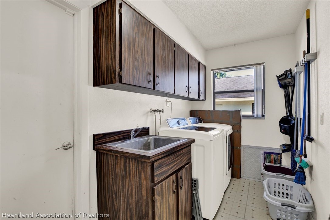 4204 Medina Way Sebring, FL 33875 - Photo 19 of 25 a kitchen with a sink cabinets and appliances