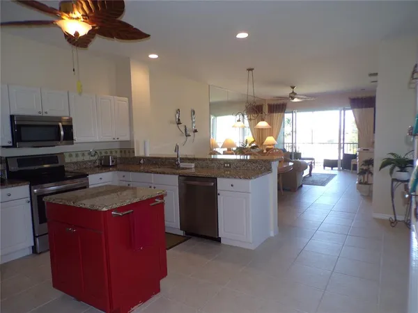 a kitchen with a stove top oven a sink a counter space and cabinets