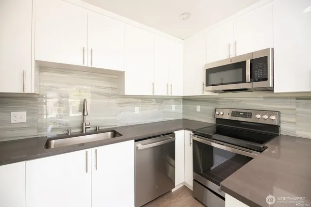 a kitchen with a stove and a microwave