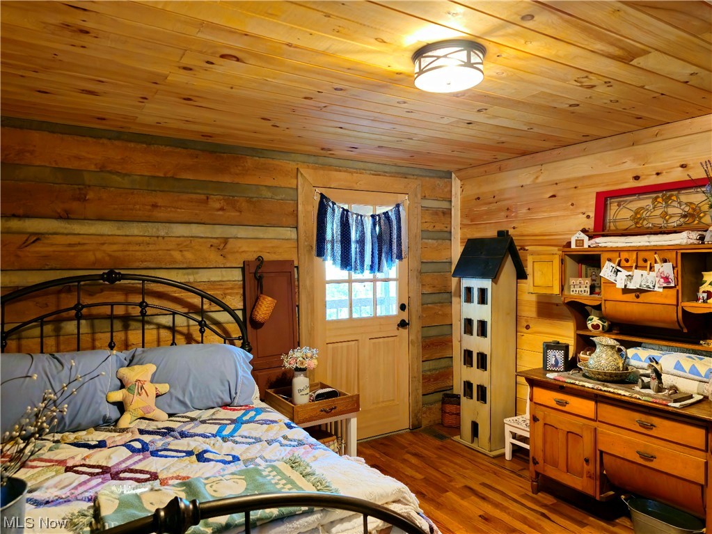 2912 Ovapa Road Wallback, WV 25285 - Photo 15 of 26 Hardwood floored bedroom with wooden walls and wood ceiling