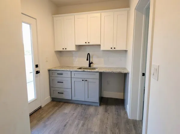 a bathroom with a granite countertop sink a toilet and a bathtub