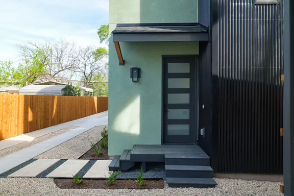 a large kitchen with stainless steel appliances refrigerator a stove and wooden floor