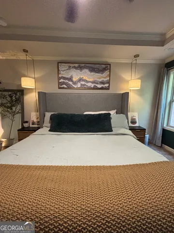 a bedroom with a bed and window