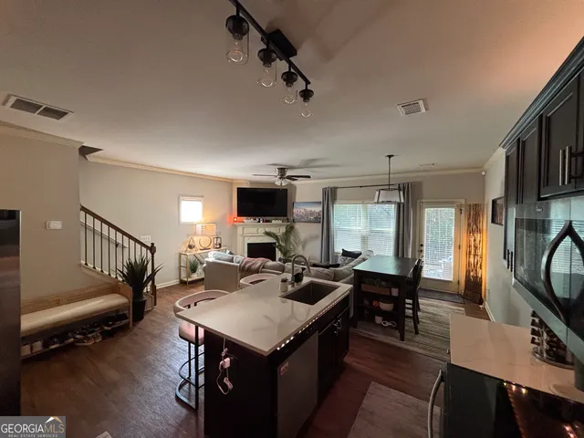 a view of a livingroom with furniture a rug and a window