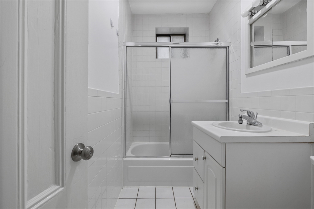 907 Boylston Street, Unit 32 Boston, MA 02115 - Photo 4 of 9 a bathroom with a sink toilet and shower