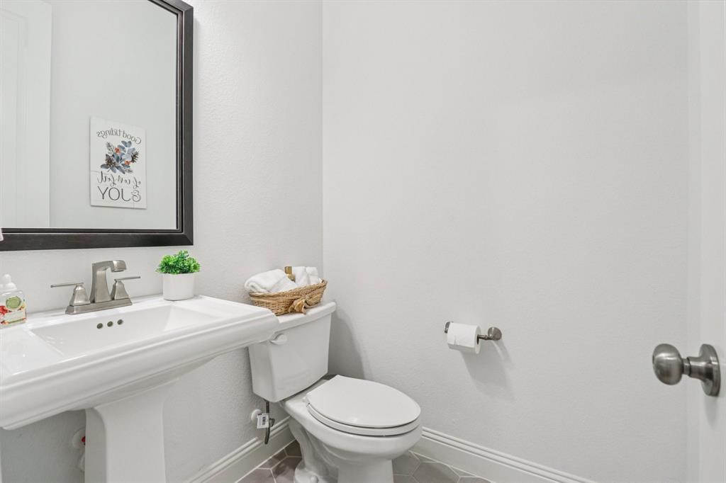 8277 Halifax The Colony, TX 75056 - Photo 27 of 37 a bathroom with a sink mirror and toilet