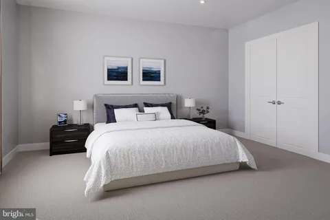 a bedroom with a bed and a night stand