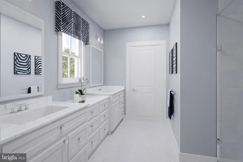 a bathroom with a double vanity sink window and a bathtub