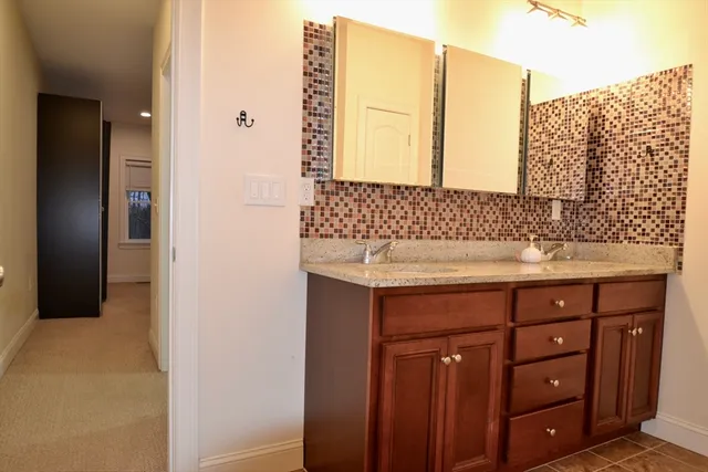 a bathroom with a sink vanity and a mirror