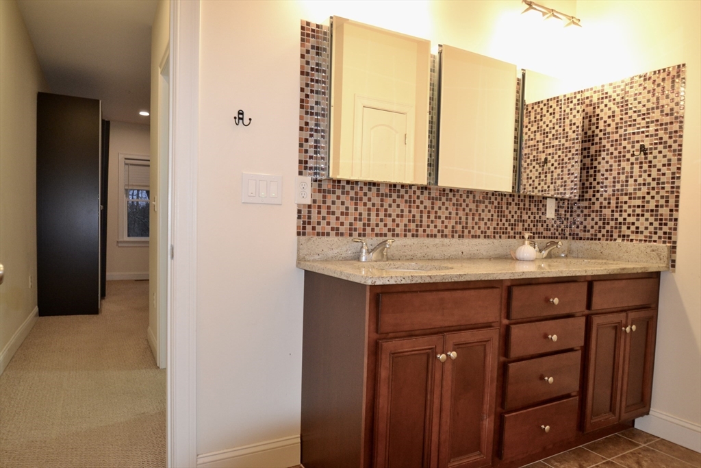 8 Cheyenne Valley, Unit 8 Westford, MA 01886 - Photo 15 of 27 a bathroom with a sink vanity and a mirror
